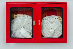 Fire hose cabinet on white wall